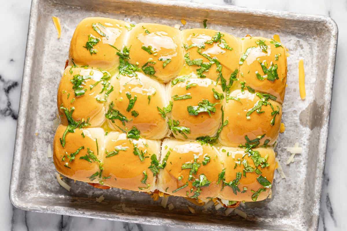 Barbecue chicken sliders brushed with cilantro butter. 