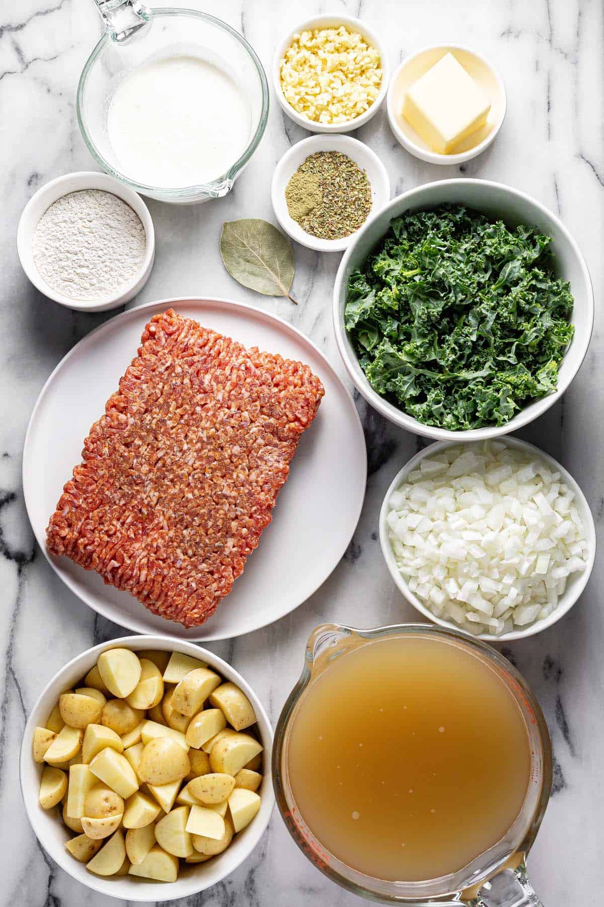 Bowls of ingredients to make Italian sausage soup. 