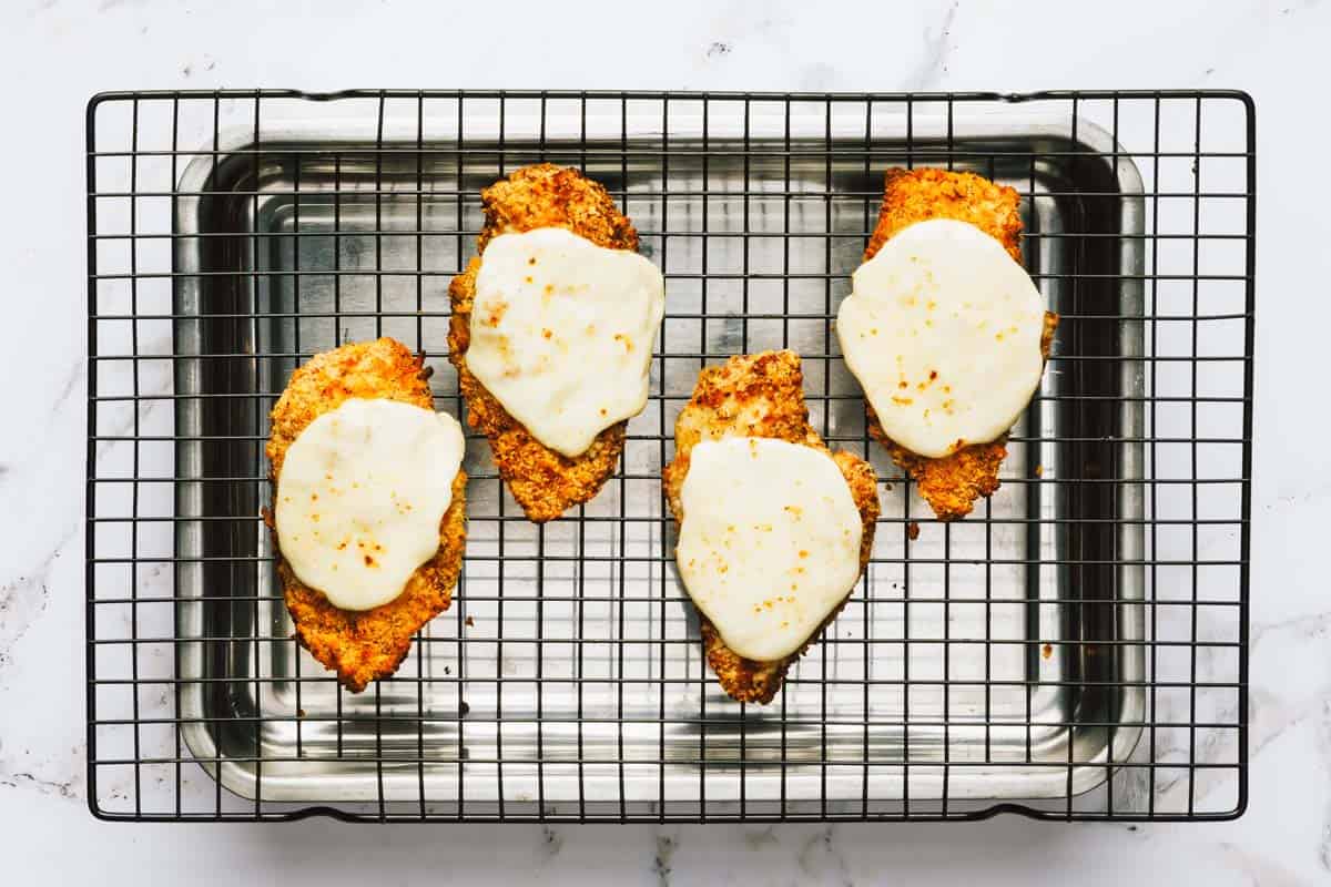 Fresh mozzarella cheese broiled on top of crispy chicken Parmesan cutlets. 