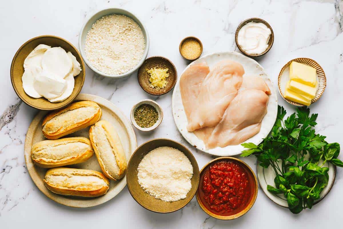 Bowls of ingredients to make chicken Parmesan sandwiches. 