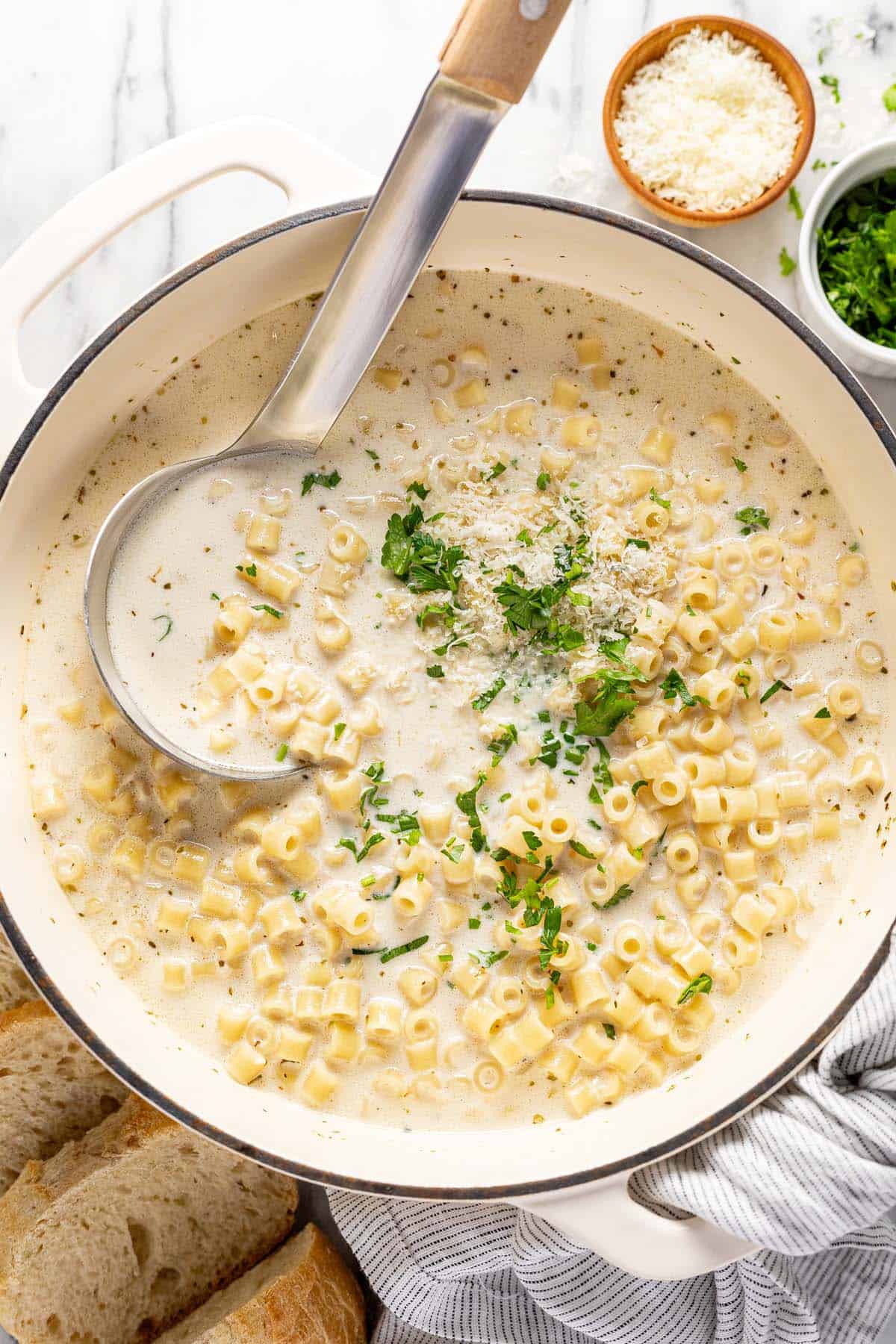 Large pot filled with creamy garlic Parmesan pasta soup. 