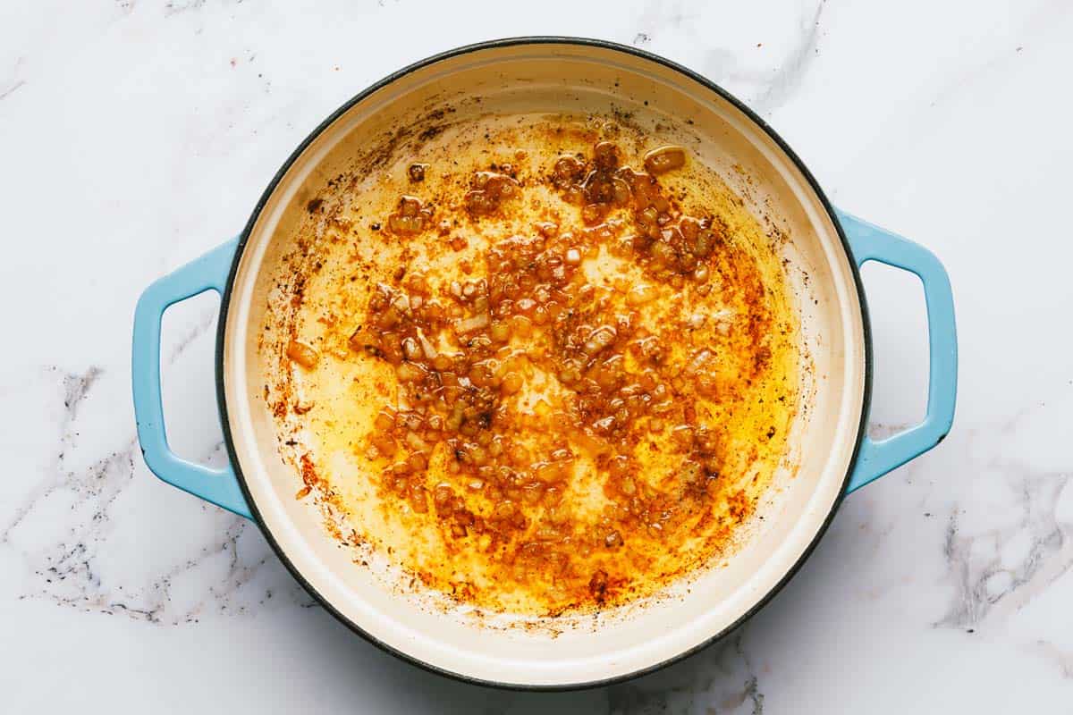 Melted butter, onions, and garlic in a large saute pan. 