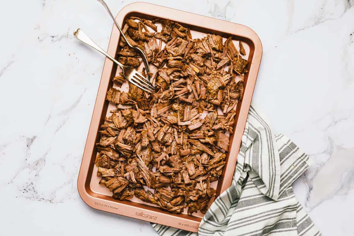 Shredded beef on a large sheet pan. 