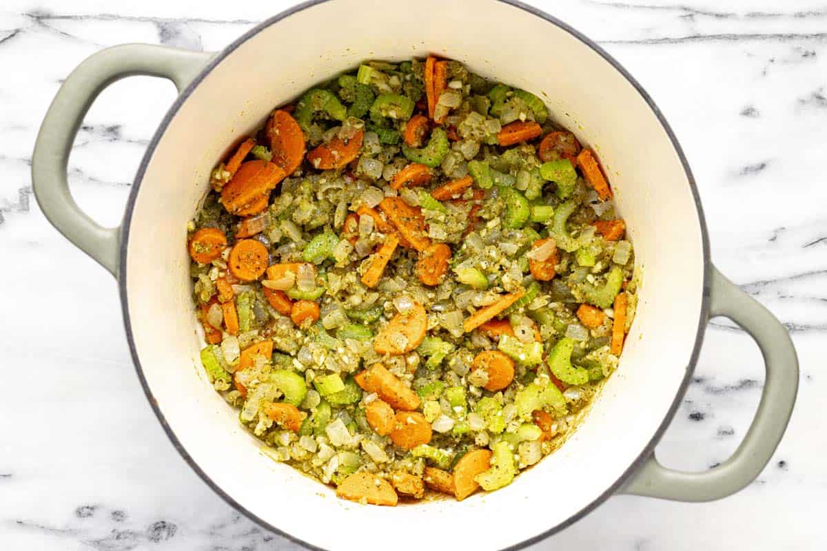 Large pot filled with sauteed veggies, garlic, herbs, and flour. 