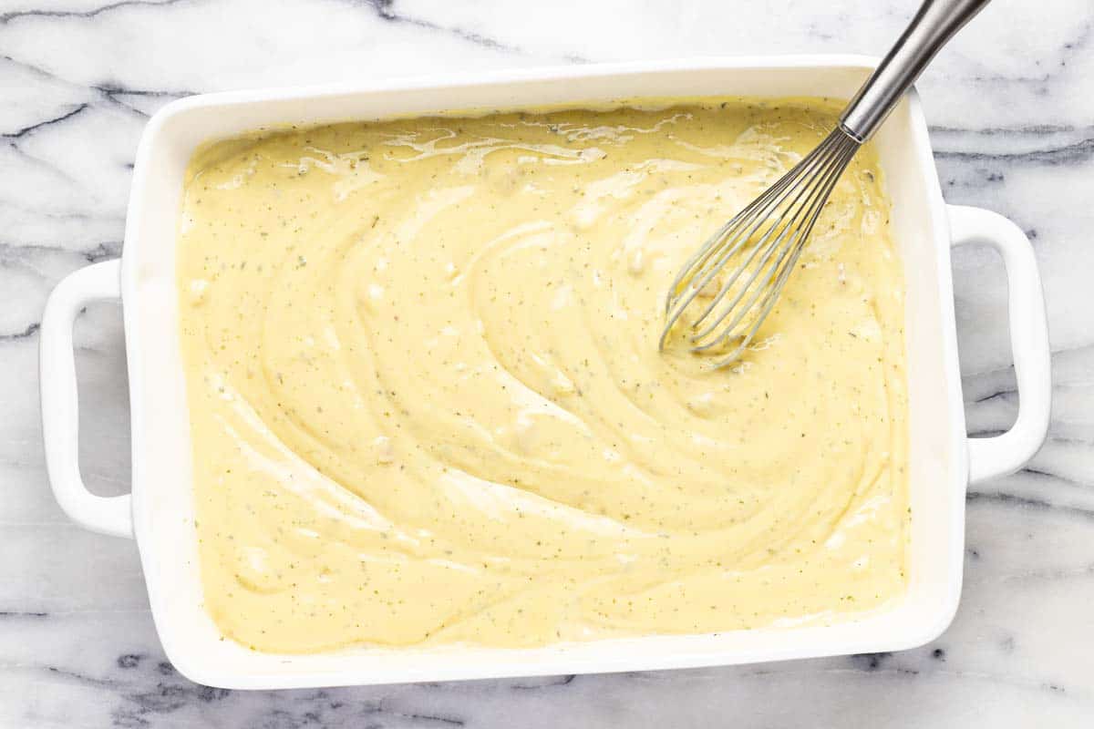 Baking dish with creamy sauce for chicken and rice. 