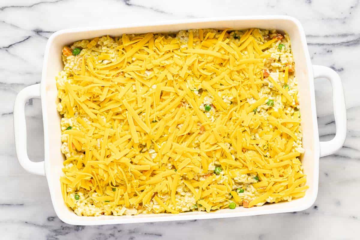 Shredded cheese on top of chicken casserole. 