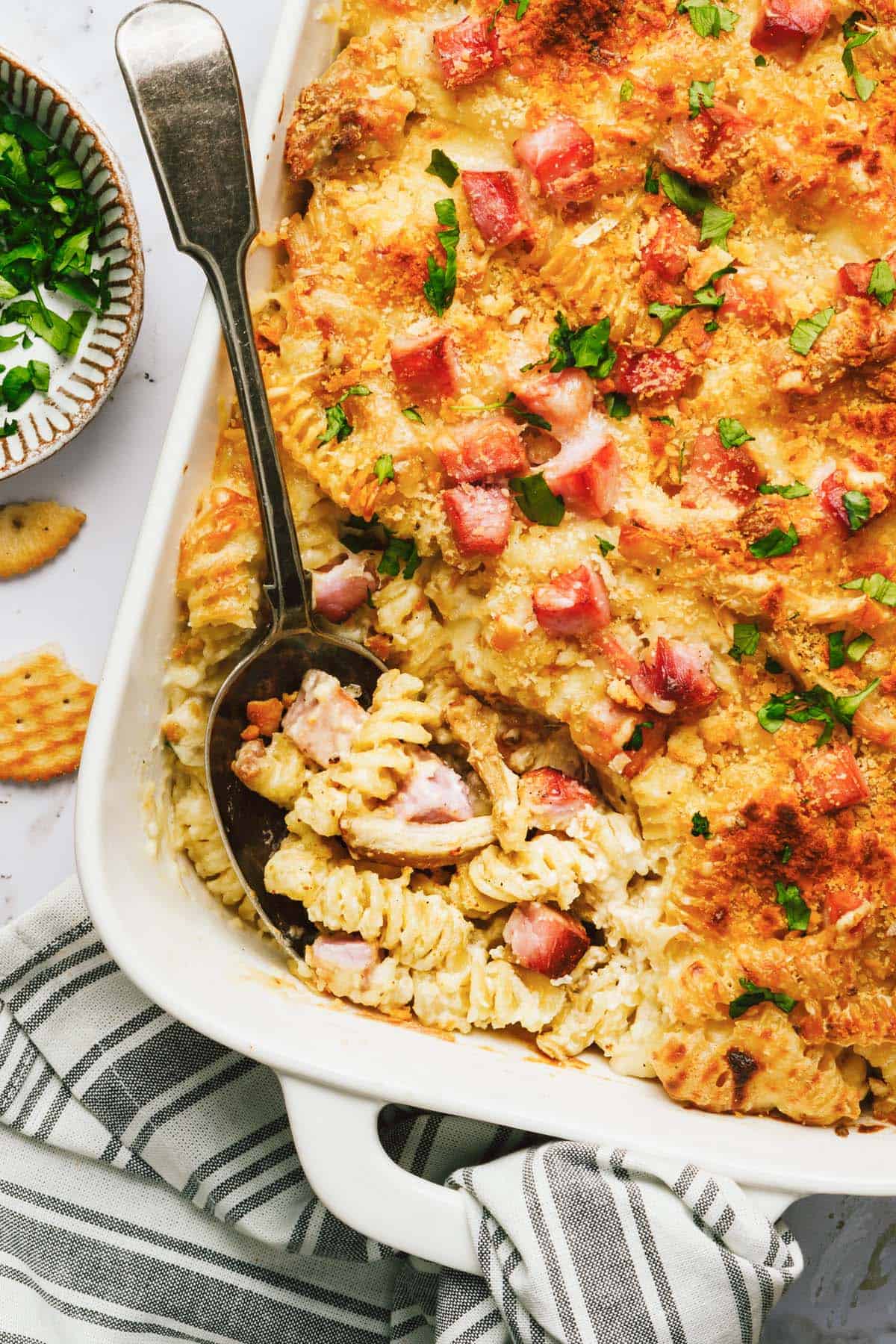 A spoonful of creamy noodles in the chicken cordon bleu casserole. 