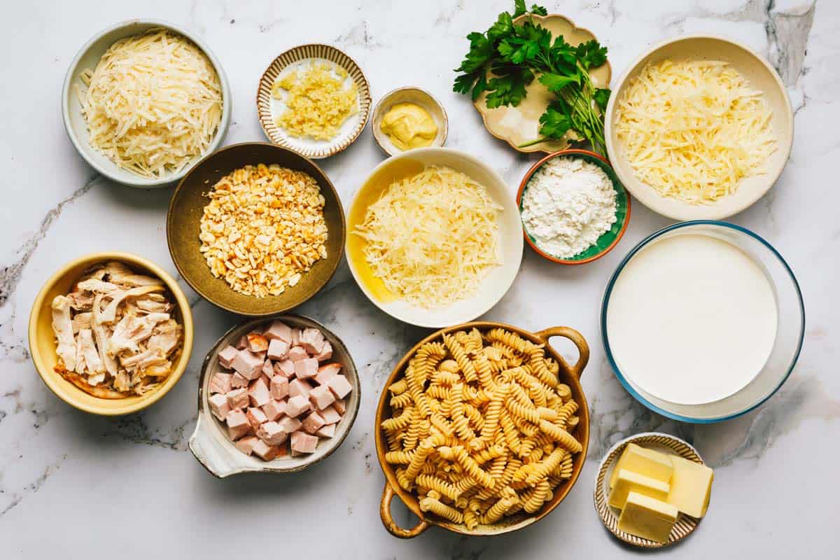 Bowls of ingredients to make chicken cordon bleu casserole. 