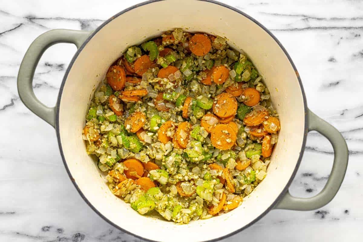 Large pot with sauteed veggies, herbs, and garlic. 