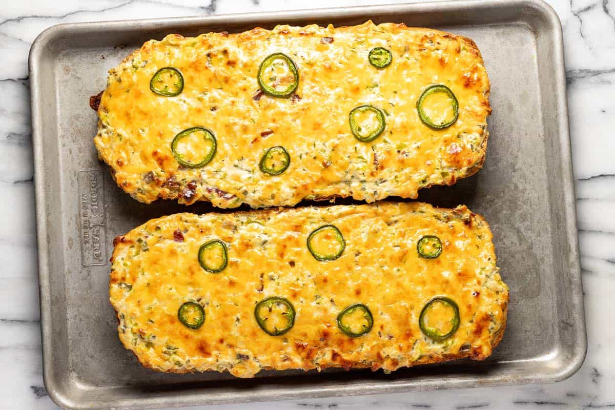 Freshly baked jalapeno popper bread on a baking sheet. 