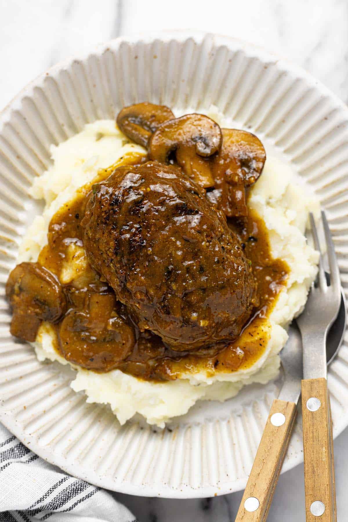 Salisbury steak and mushroom gravy on top of mashed potatoes. 