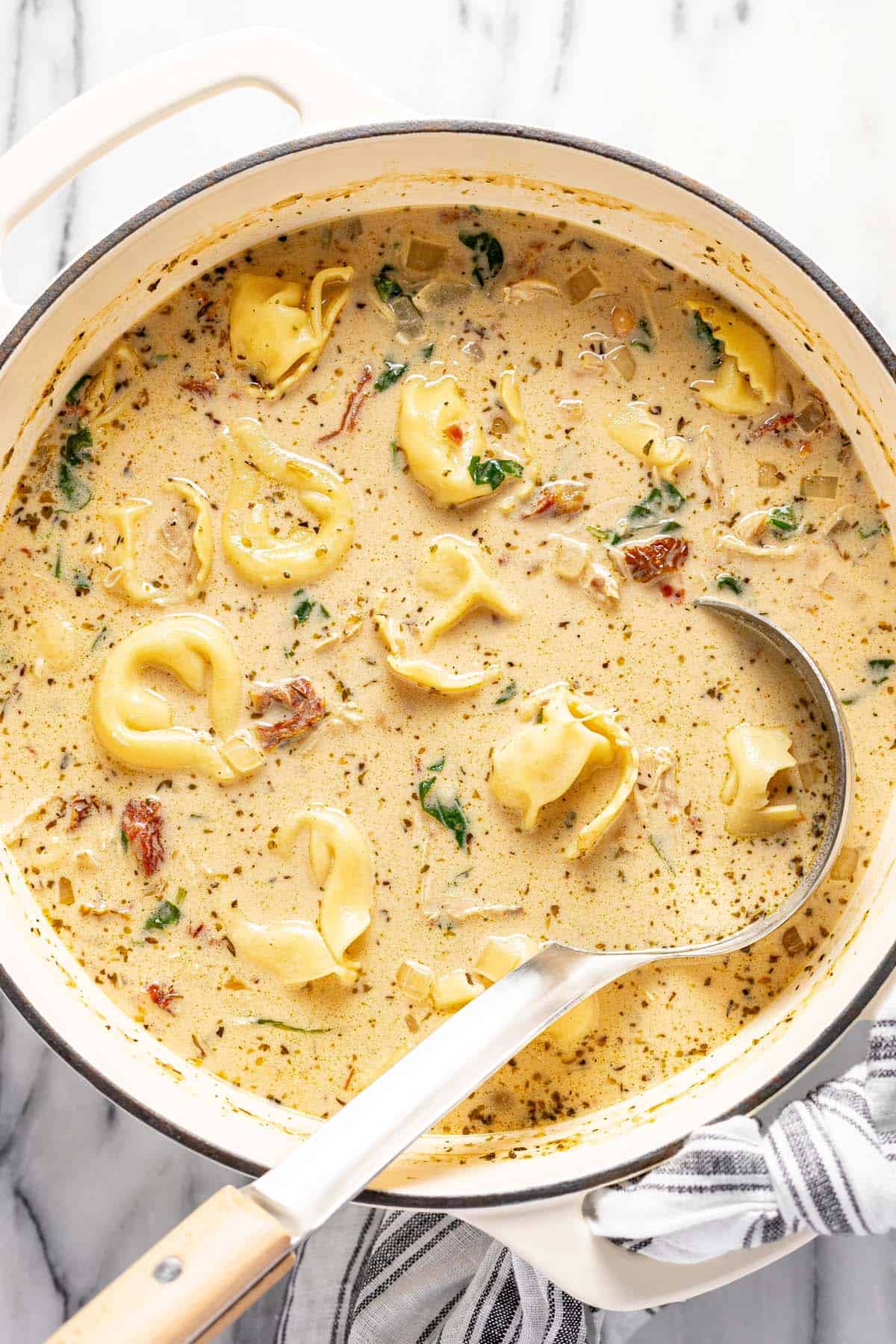 Large pot of creamy Tuscan chicken tortellini soup. 