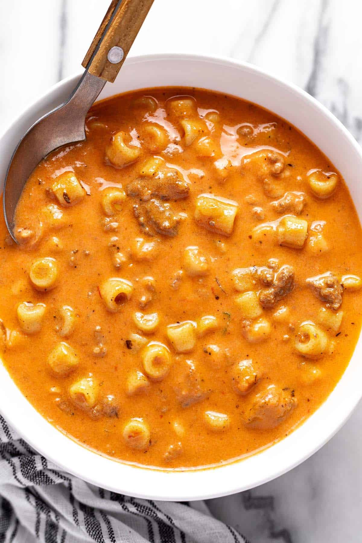 Bowl of creamy tomato soup with ground beef and noodles. 