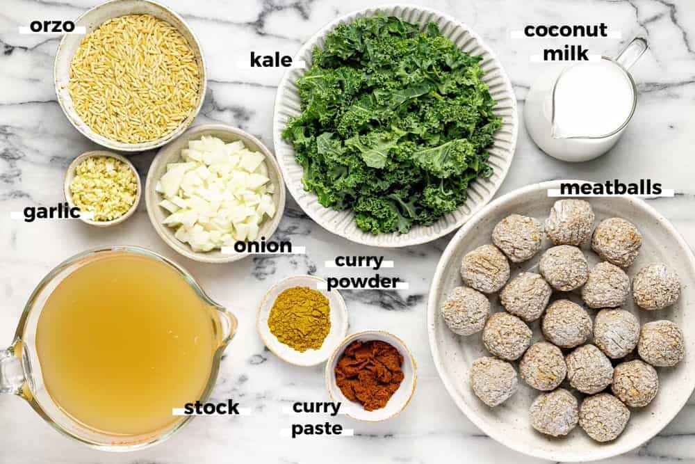 Bowls of ingredients to make curry coconut meatball soup. 