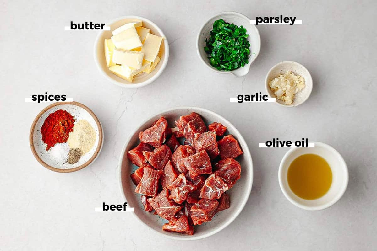 Bowls of ingredients to make garlic butter steak bites. 