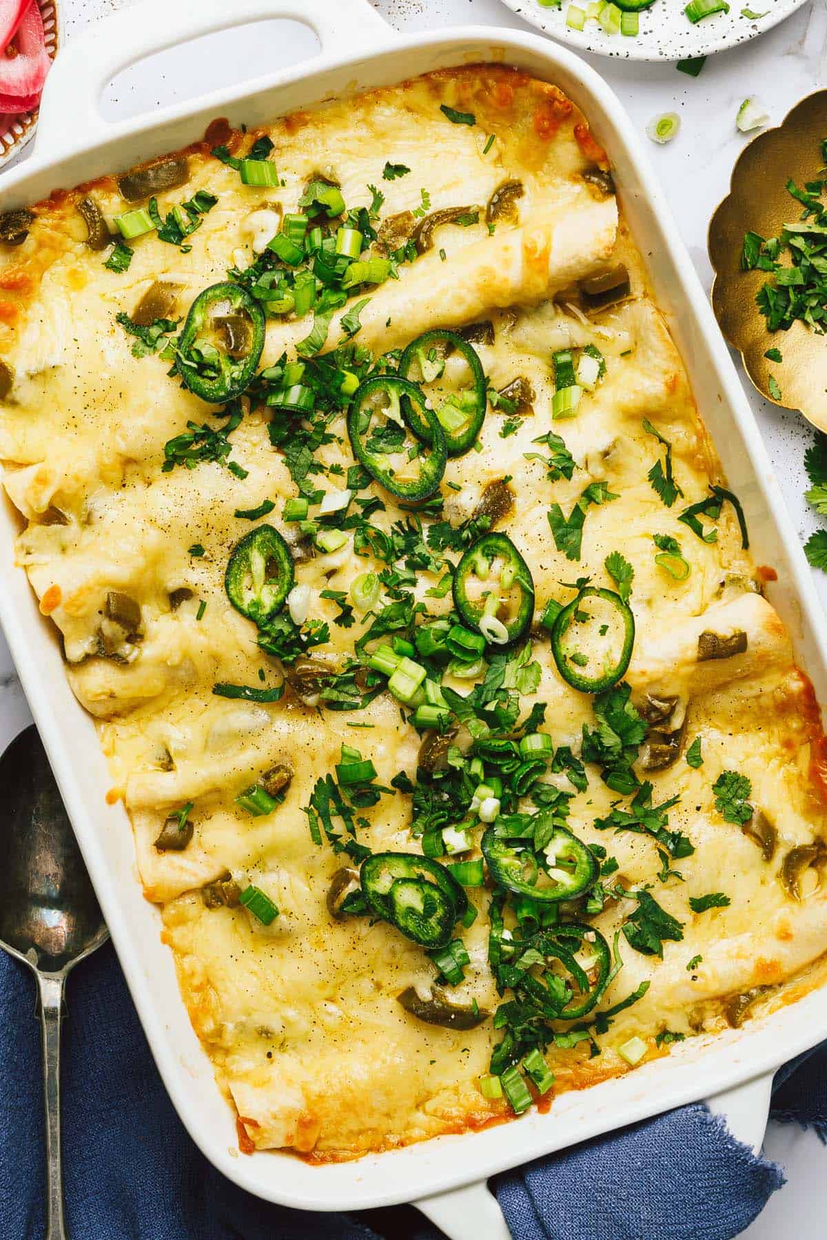 Large baking dish filled with white chicken enchiladas. 