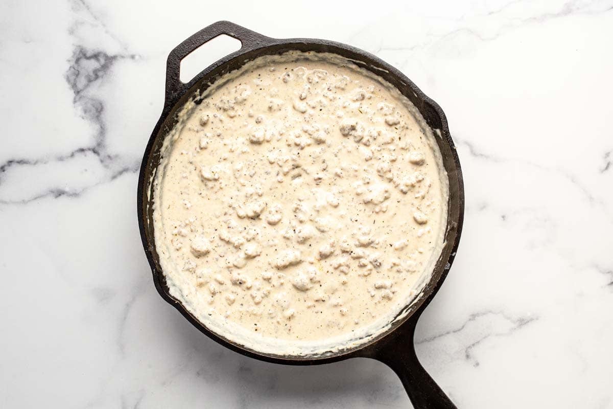 Homemade sausage gravy in a large cast iron pan. 