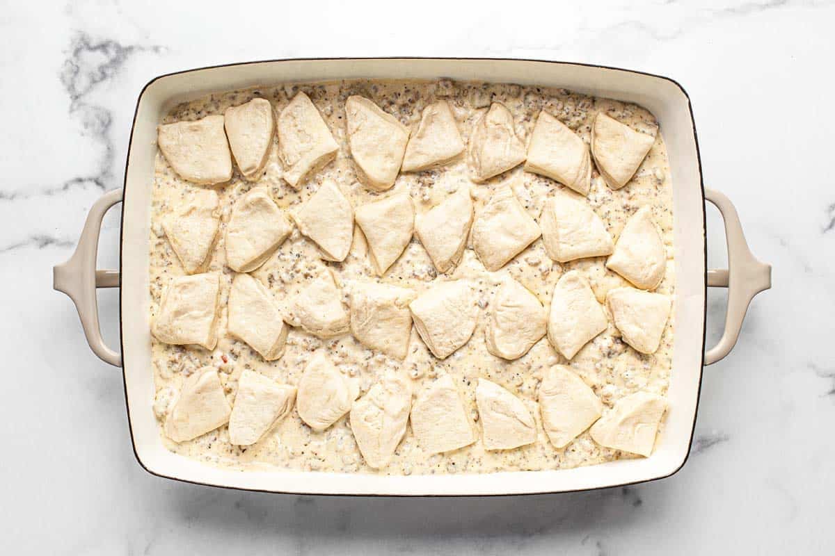 Cut up biscuits on top of sausage gravy in a large baking dish. 