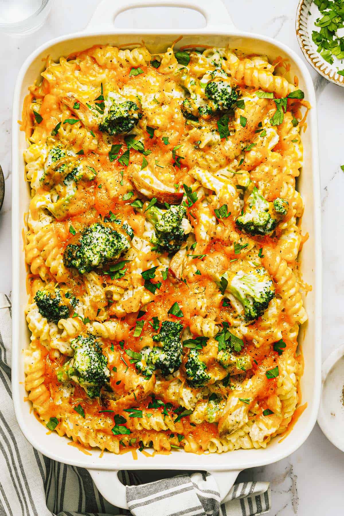 Large pan filled with cheesy broccoli chicken bake. 