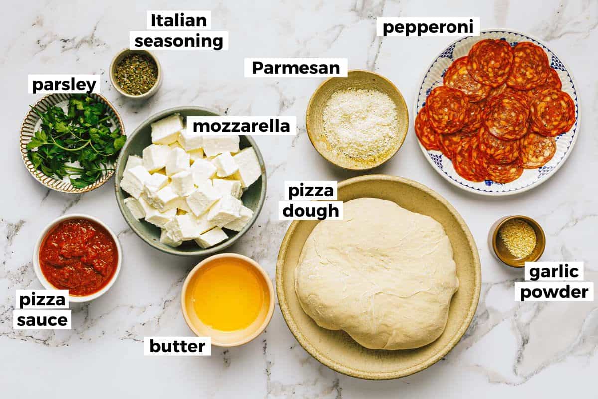 Bowls of ingredients to make pepperoni pizza bites. 