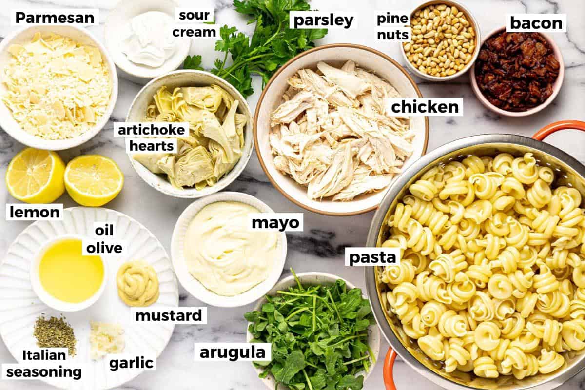 Bowls of ingredients to make chicken pasta salad. 
