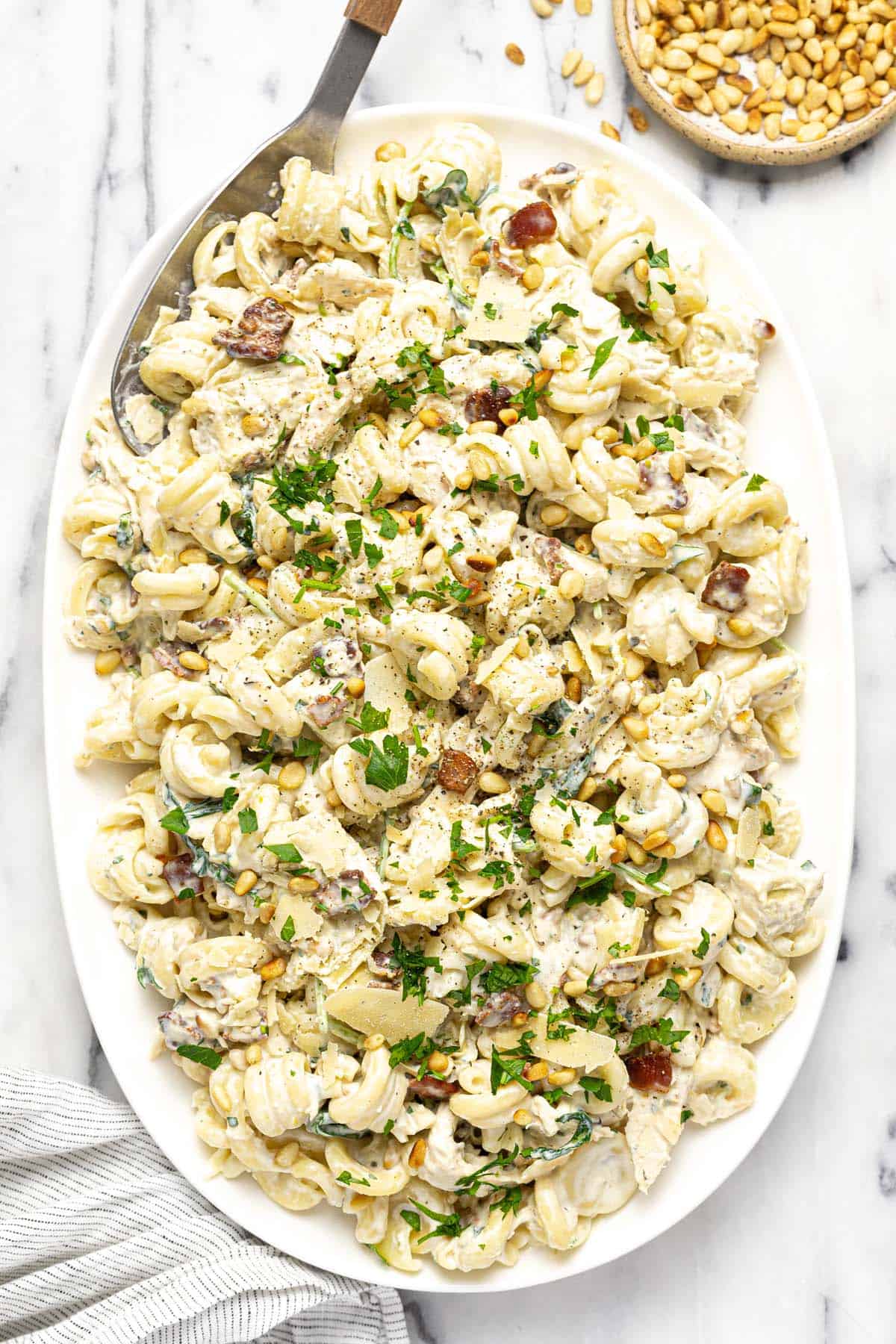 Large serving platter with creamy chicken pasta salad.