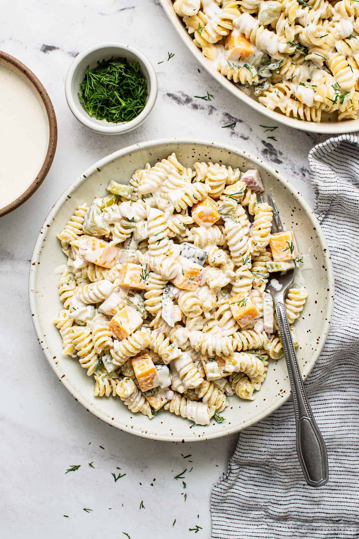 Bowl of dill pickle pasta salad with a fork.