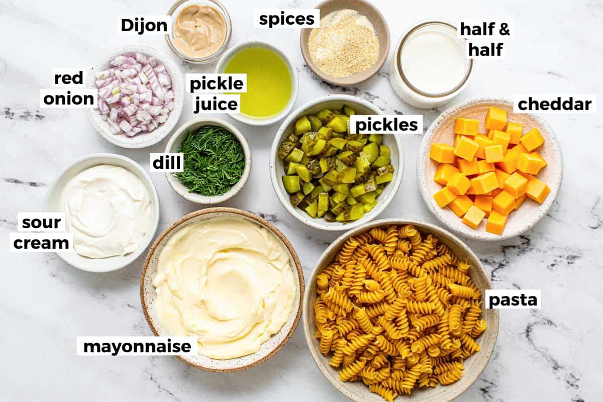 Bowls of ingredients to make dill pickle pasta salad. 