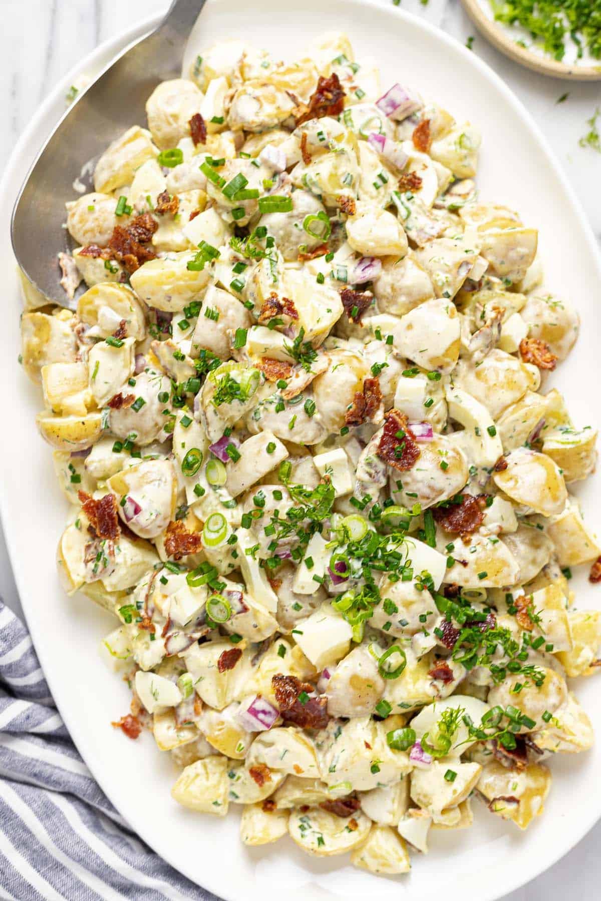 Large serving platter filled with homemade potato salad. 