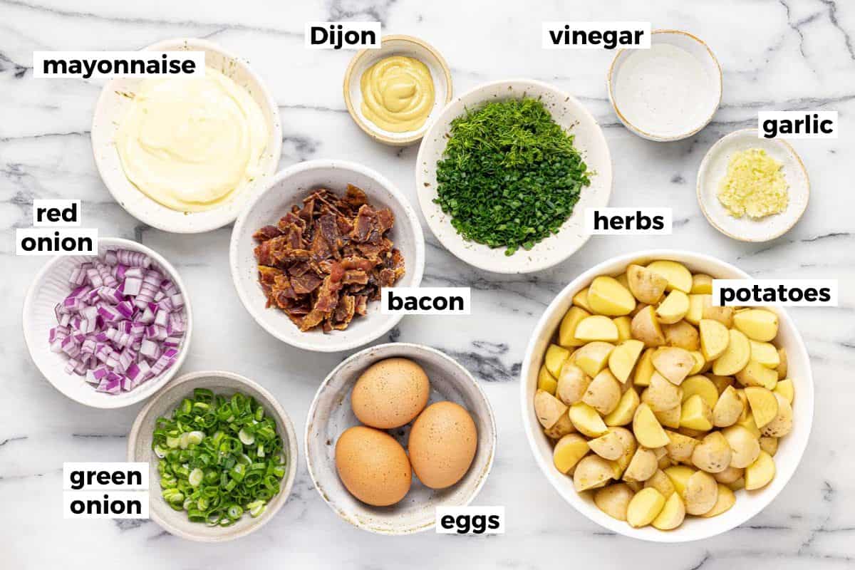 Bowls of ingredients to make homemade potato salad. 