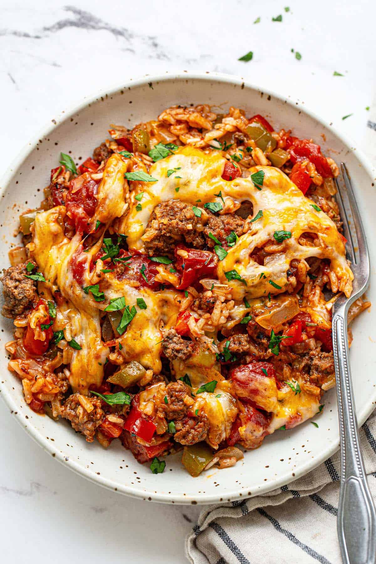 Bowl of stuffed pepper casserole with a fork. 