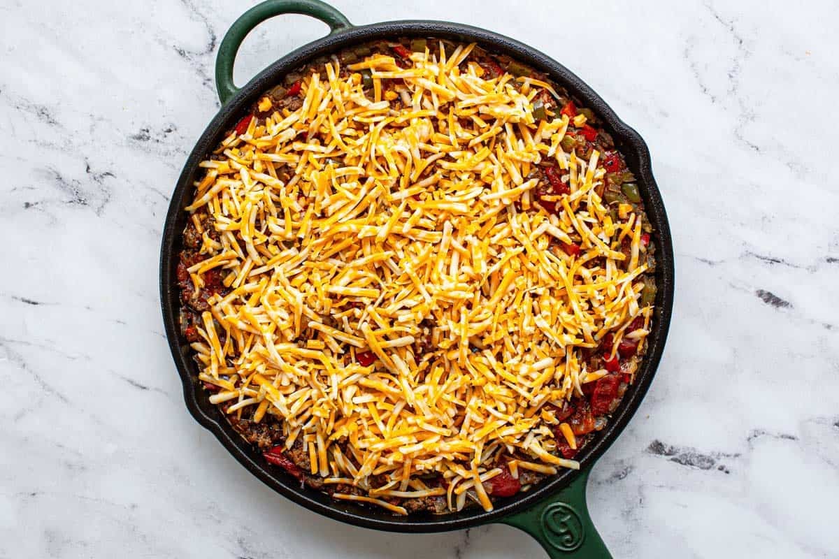 Stuffed pepper casserole topped with shredded cheese. 