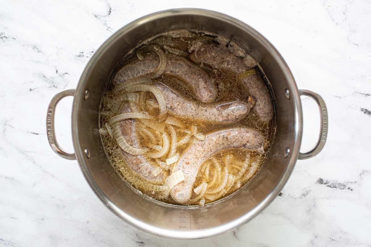 Large pot of beer, onions, and brats. 