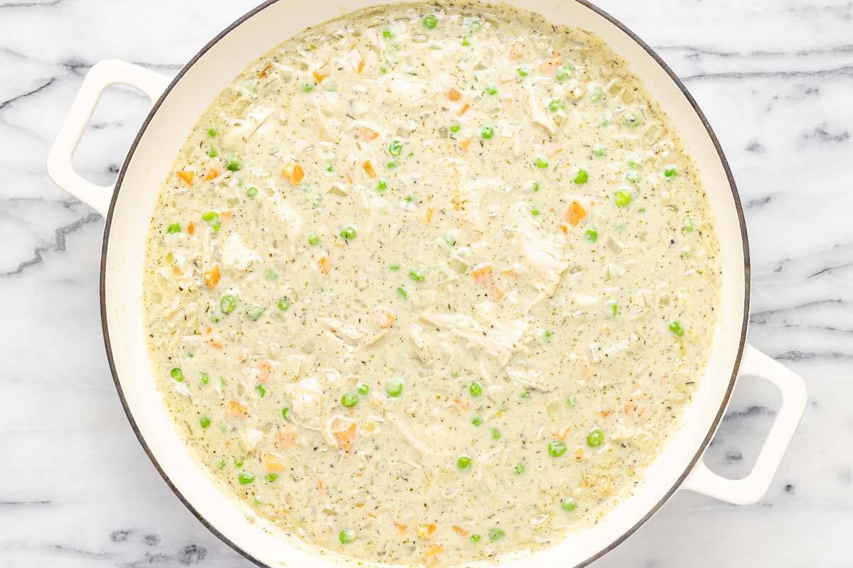 Creamy chicken cobbler sauce in a large pan. 