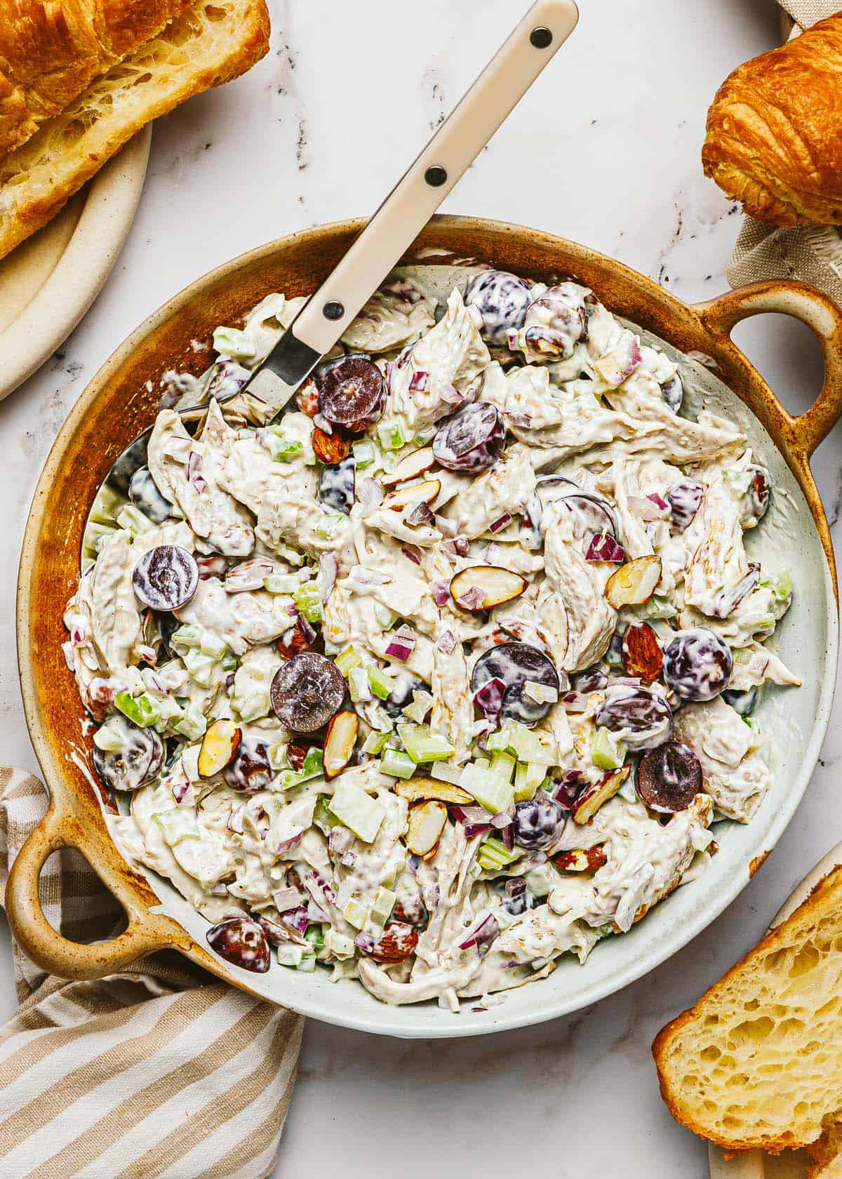 Bowl of rotisserie chicken salad with grapes and almonds.