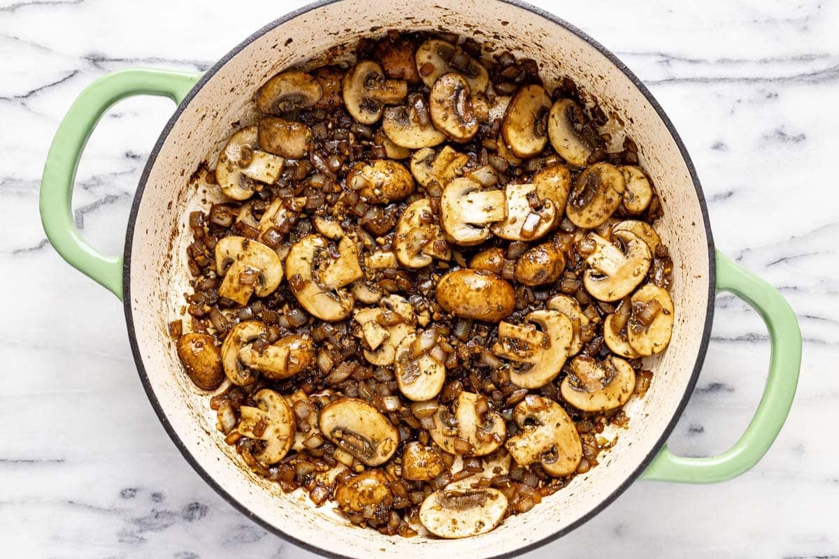Sauteed onions and mushrooms in a large saute pan. 