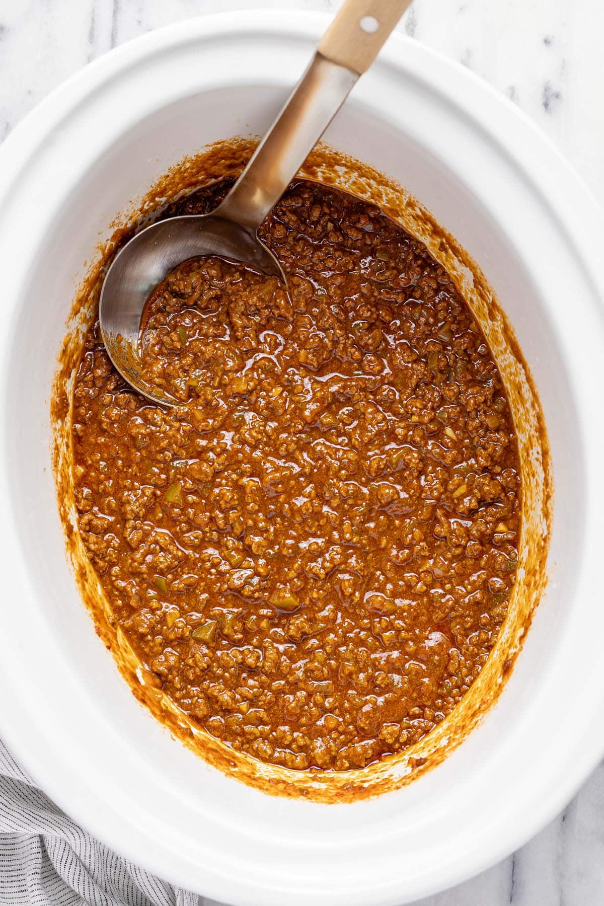 Large crock pot filled with homemade sloppy joe mixture.