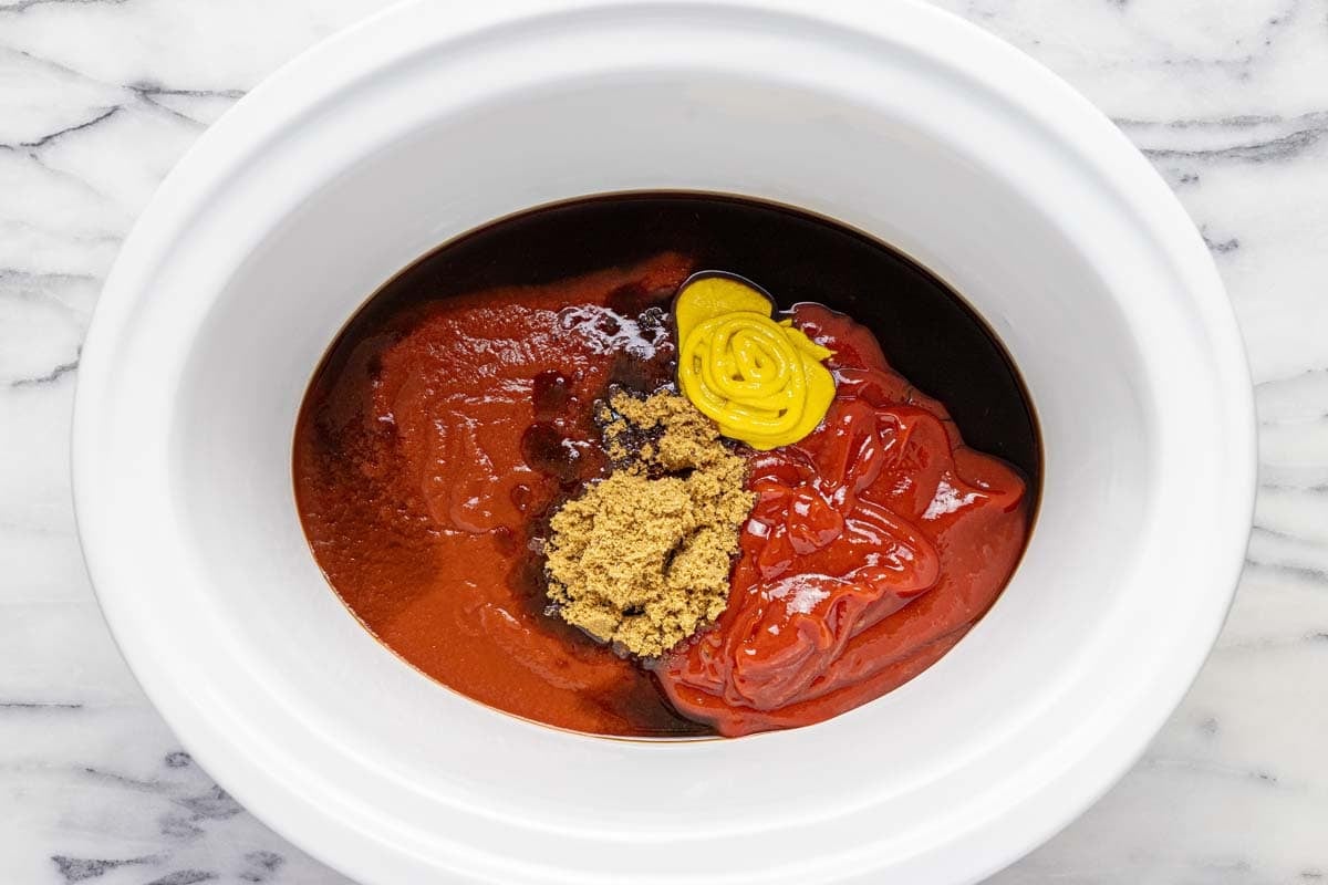 Crock pot with ingredients to make sloppy joe sauce. 