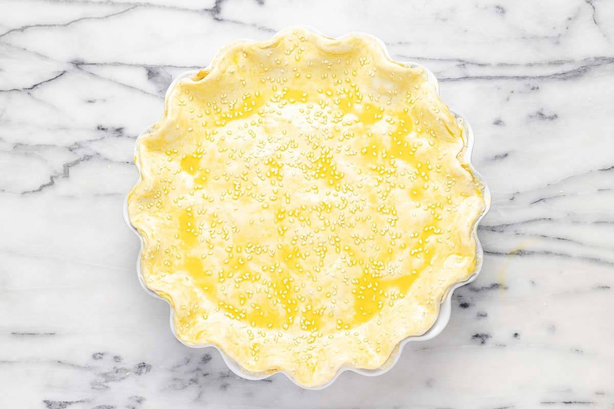 Puff pastry dough brushed with egg wash and sesame seeds. 