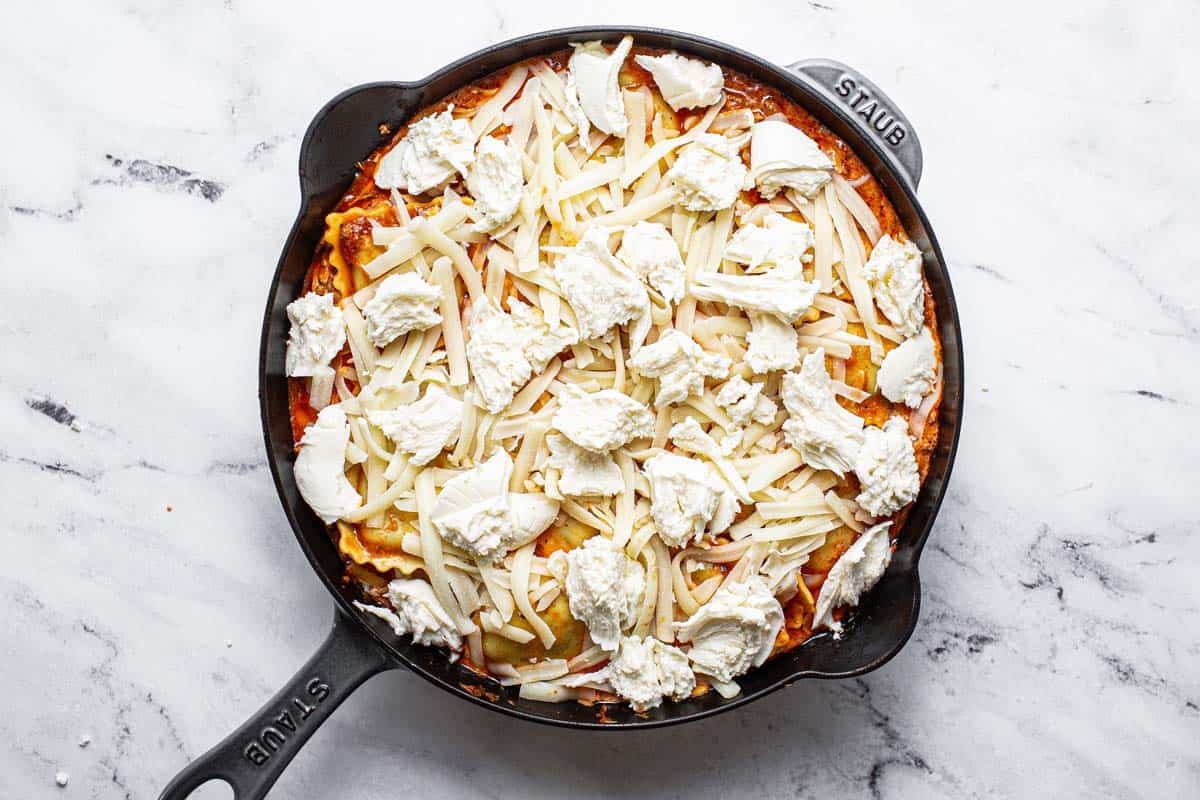 Ravioli and meat sauce topped with cheeese. 