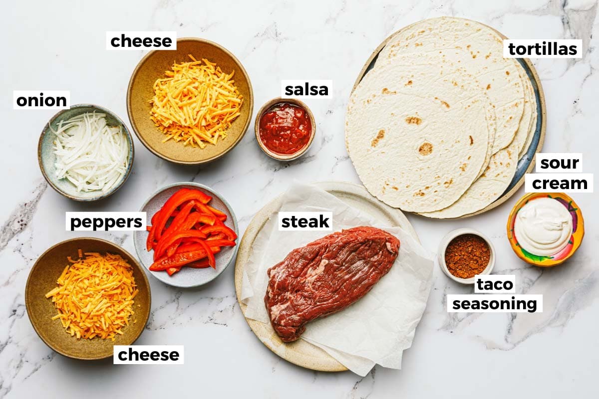 Bowls of ingredients to make steak quesadillas. 