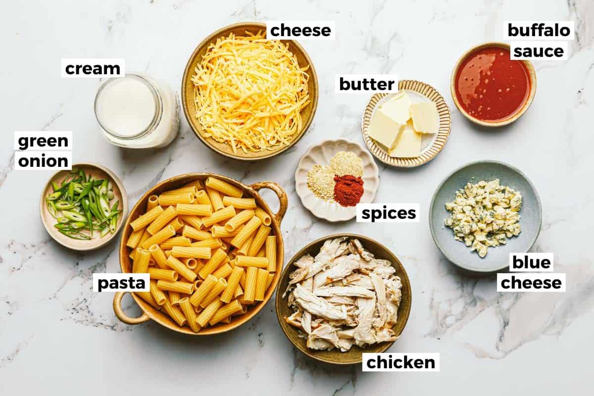 Bowls of ingredients to make buffalo chicken pasta. 