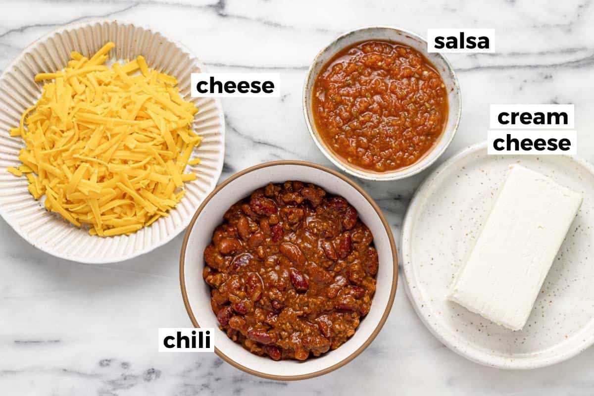 Bowls of ingredients to make chili cheese dip. 