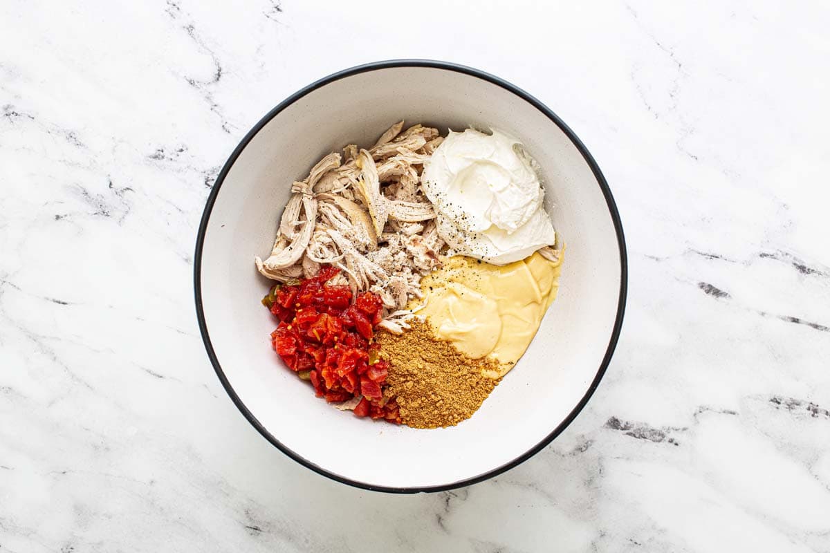 Bowl with ingredients to make the filling for king ranch chicken casserole. 