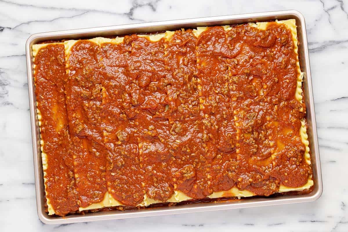 Layers of lasgna on a sheet pan. 