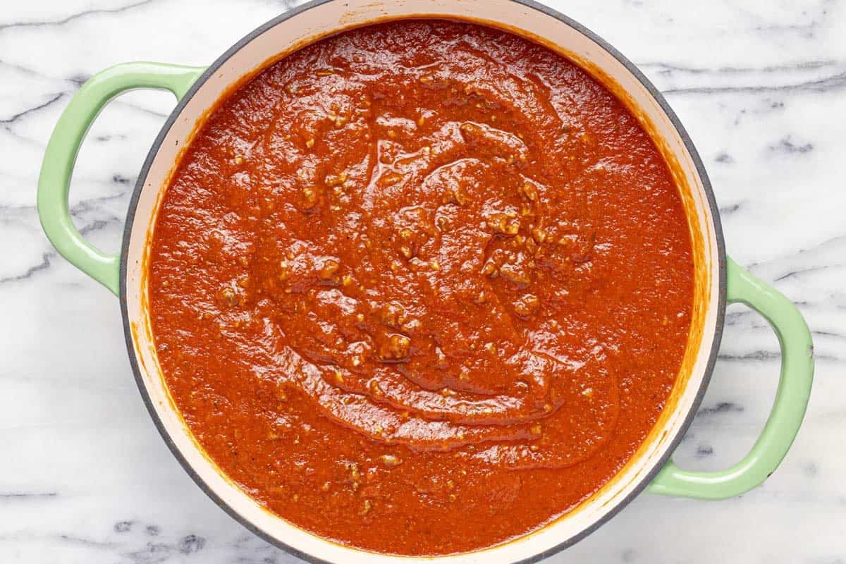Large pan filled with meat sauce for lasagna. 