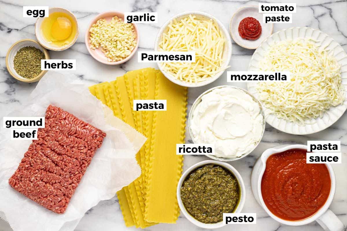 Bowls filled with ingredients to make sheet pan lasagna. 