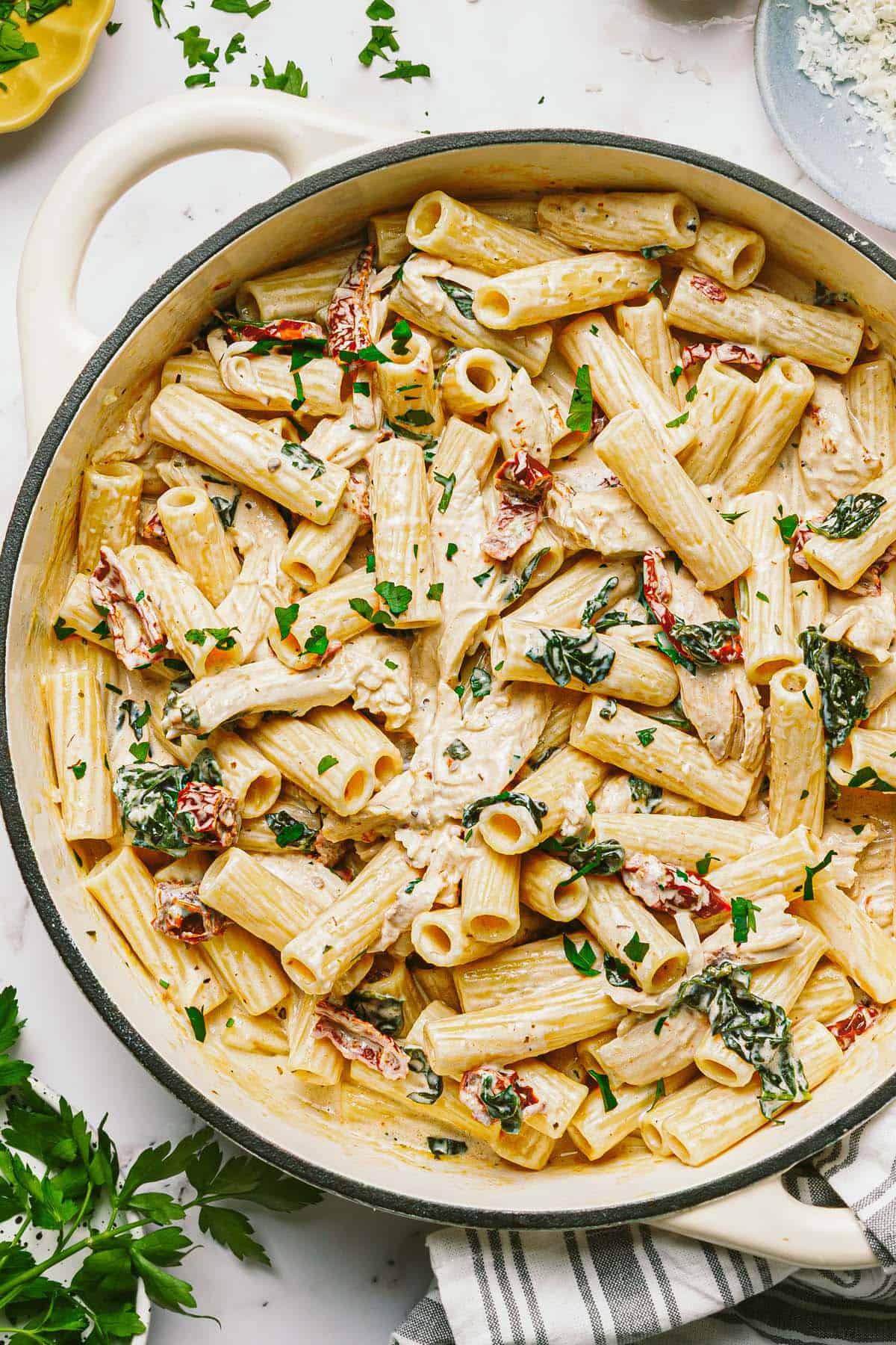 Large pan filled with creamy Tuscan chicken pasta. 
