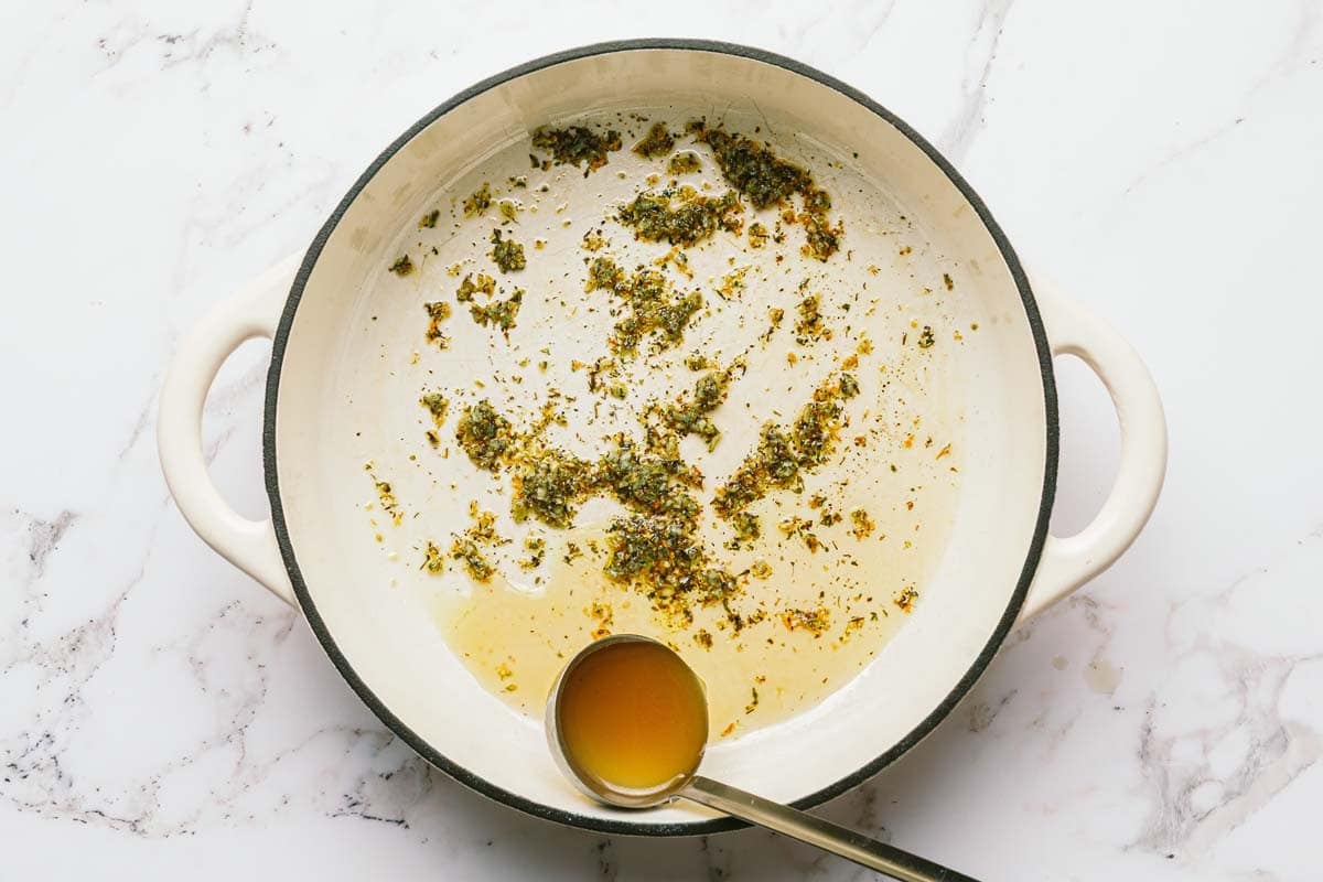 Large pan with minced garlic and dried herbs. 