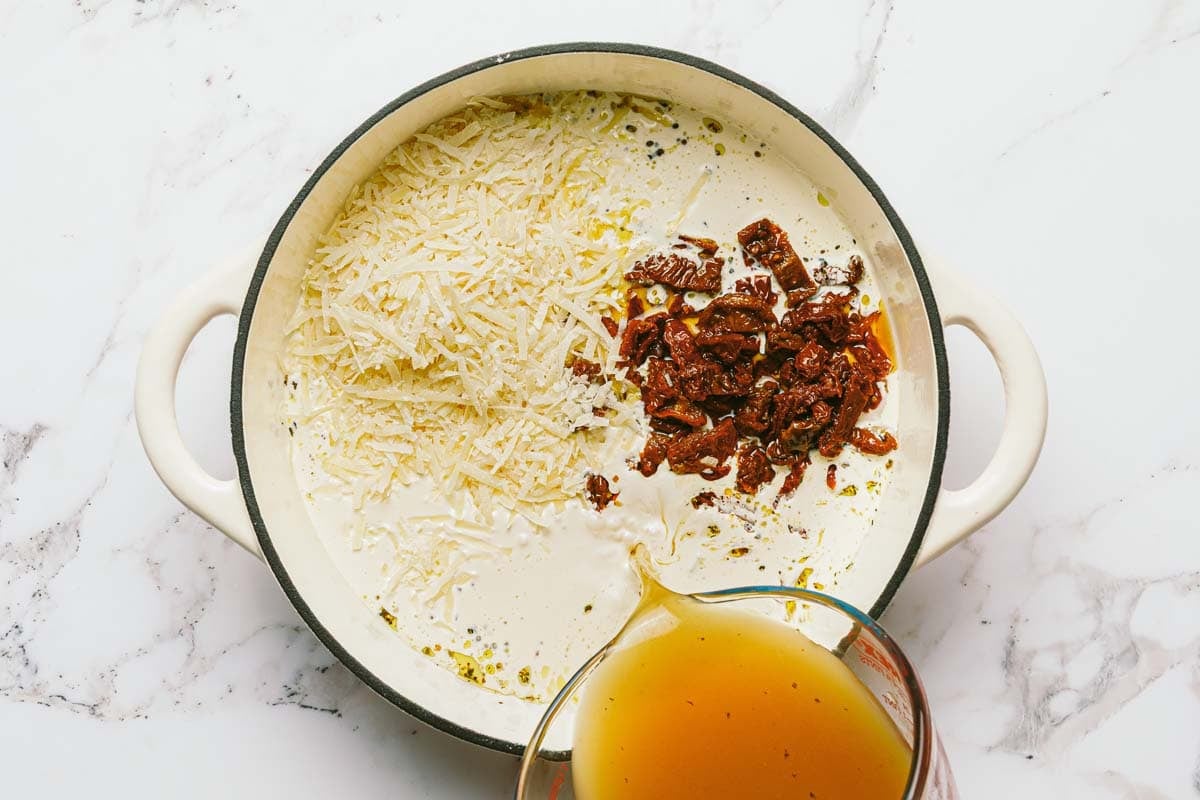 Large pan with creamy parmesan sauce for chicken pasta. 